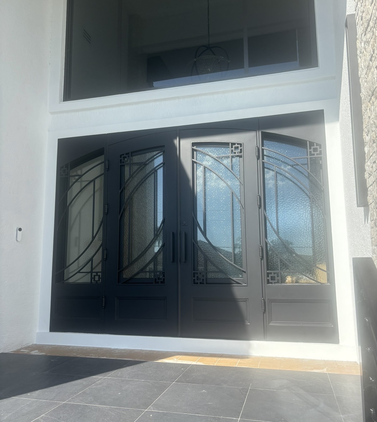 Custom mahogany arched double doors with iron scrollwork by PDA Doors & More